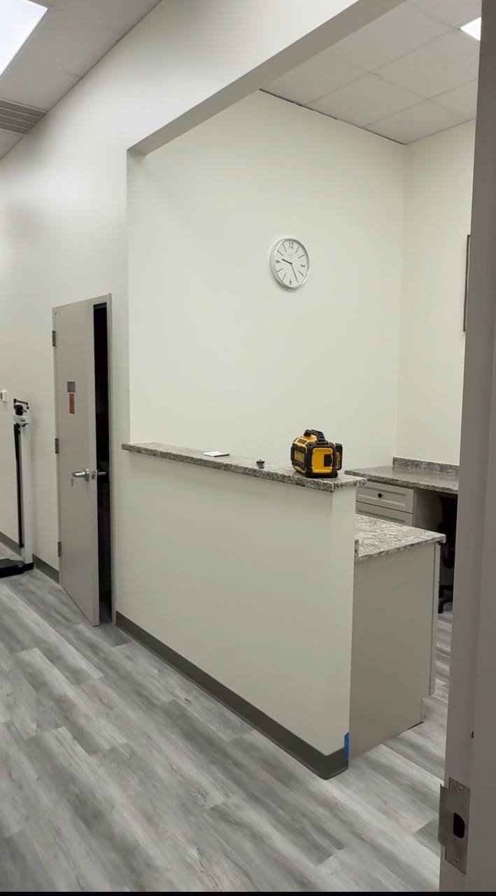Finished commercial reception — granite counter top, LVP floor
