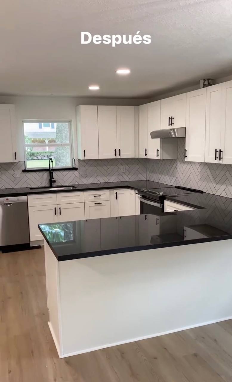 Finished kitchen remodel with white cabinets, granite counters, and tile backsplash